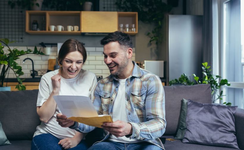 Happy young couple with paper work