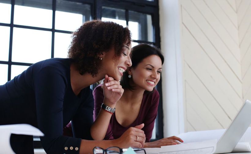 Couple looking at laptop and smiling 