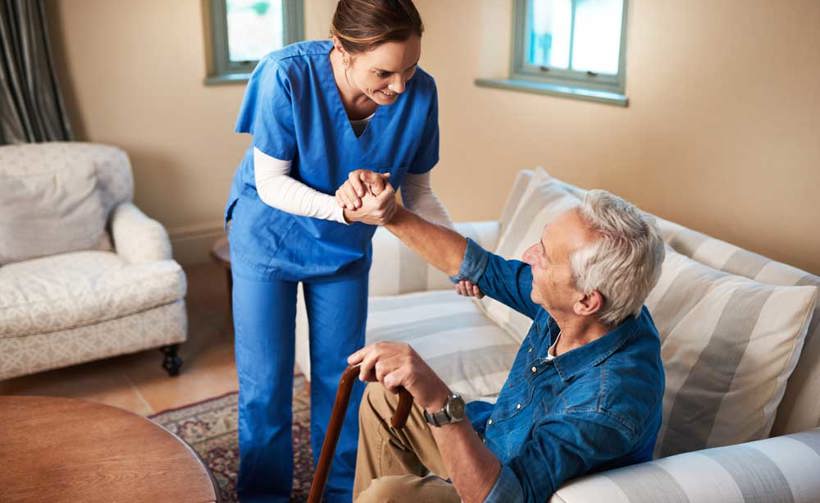 Nurse assisting elderly patient