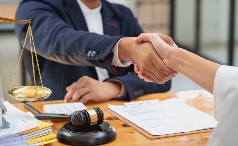 Solicitor shaking hands with client