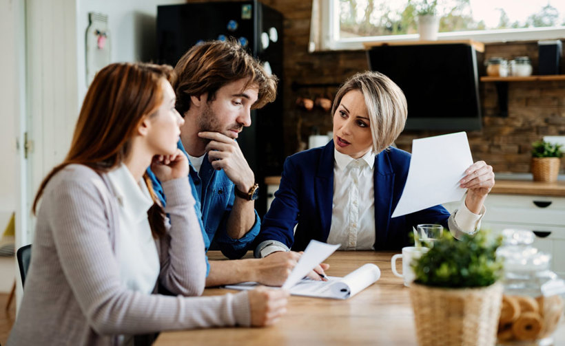Couple at home reviewing paperwork